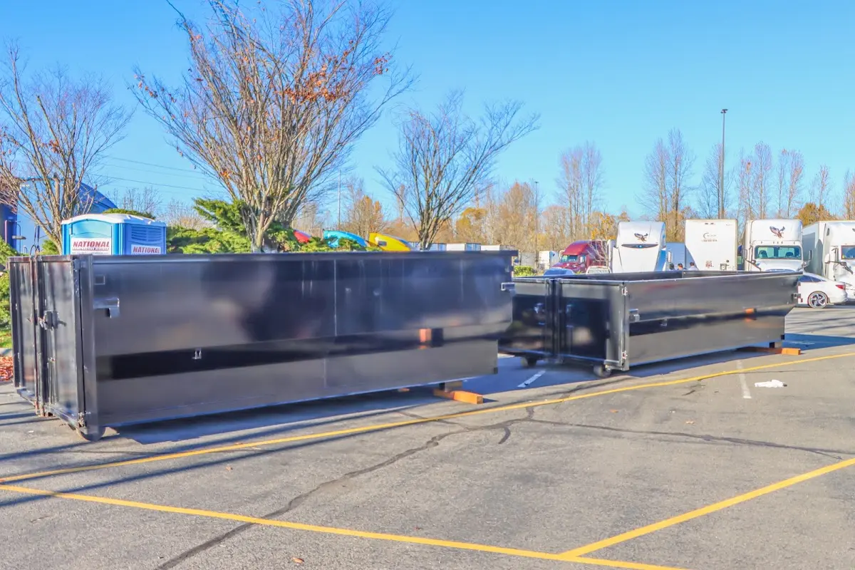 Professional dumpster rental service with roll-off container on residential driveway in Starkville